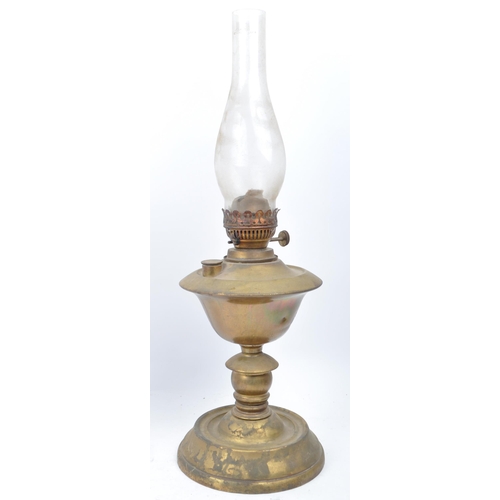 377 - A collection of Victorian and later table top oil lamps. Brass and copper construction with an iron ... 