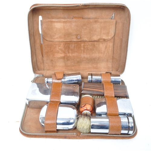 399 - A large collection of vintage 20th century travelling case vanity sets. Seven in total in the brown ... 