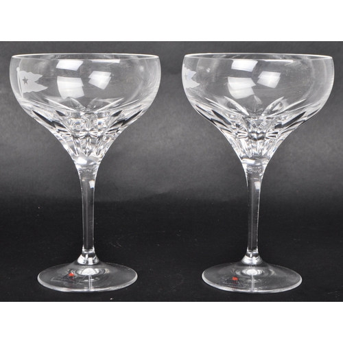 462 - A pair of later 20th Century Stuart Crystal White Star Collection champagne glasses, each with a sha... 