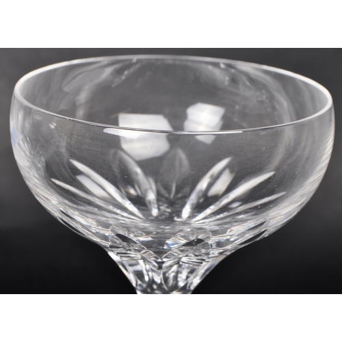 462 - A pair of later 20th Century Stuart Crystal White Star Collection champagne glasses, each with a sha... 