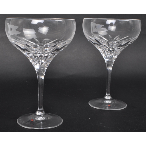 462 - A pair of later 20th Century Stuart Crystal White Star Collection champagne glasses, each with a sha... 