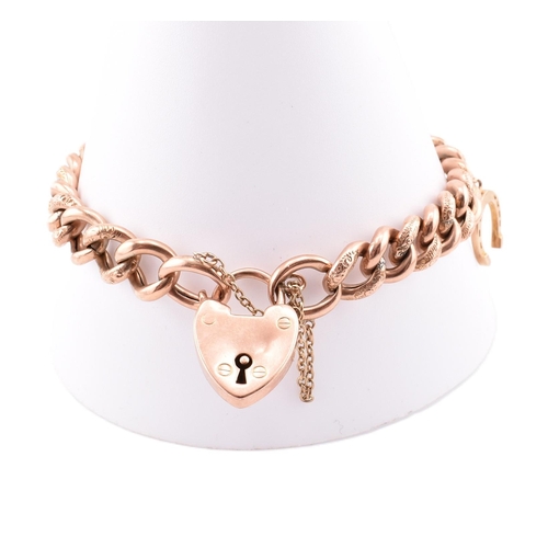 103 - A hallmarked 9ct gold engraved charm bracelet. The 9ct rose gold curb link bracelet having polished ... 