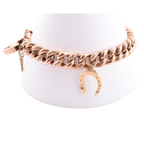 103 - A hallmarked 9ct gold engraved charm bracelet. The 9ct rose gold curb link bracelet having polished ... 