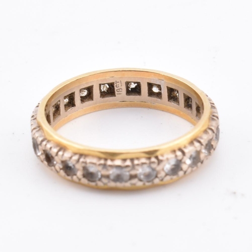 105 - An 18ct gold gem set eternity ring. Marked 18ct. Weight 4g. Size M.