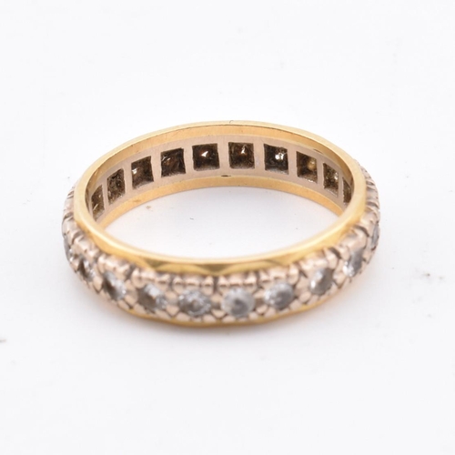 105 - An 18ct gold gem set eternity ring. Marked 18ct. Weight 4g. Size M.