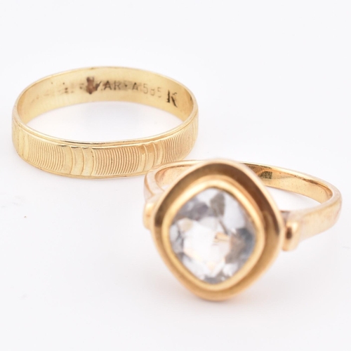 108 - Two 14ct gold rings including an aquamarine set ring. The lot to include a 14ct yellow gold and fanc... 