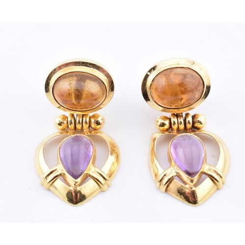 114 - A pair of 18ct gold citrine and amethyst pendant earrings. The 18ct yellow gold earrings set with te... 