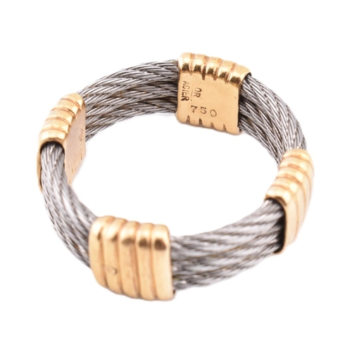 116 - An 18ct gold and steel Force 10 ring. The ring formed from three rows of stainless steel cable with ... 