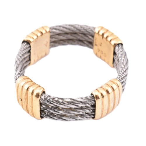 116 - An 18ct gold and steel Force 10 ring. The ring formed from three rows of stainless steel cable with ... 