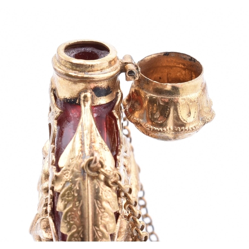 12 - A gilt and cranberry glass scent bottle. The cranberry glass scent bottle having a pierced gilt meta... 