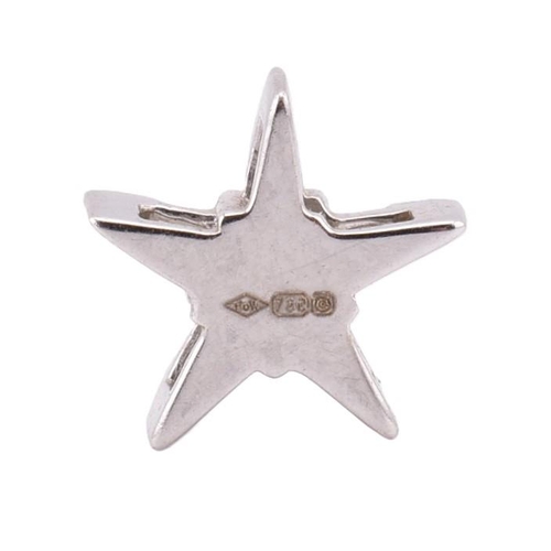 121 - A hallmarked 18ct white gold and diamond star necklace pendant. The pendant in the form of a star se... 