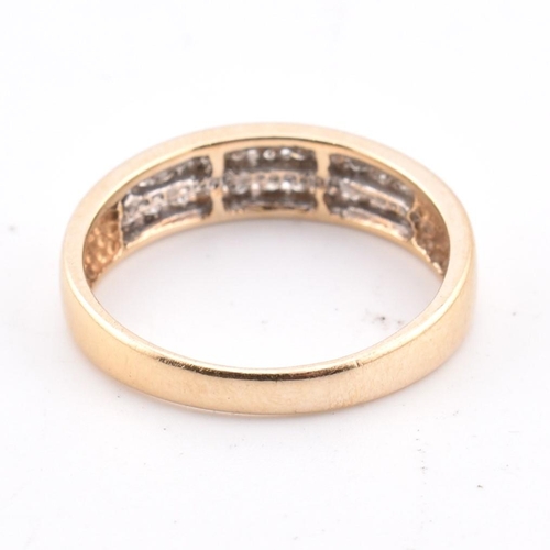 127 - A 14ct gold and diamond ring. The 14ct yellow gold ring set with two rows of eleven channel set roun... 