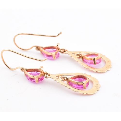 133 - A pair of 18ct gold and pink sapphire pendant earrings. The 18ct yellow gold pendant earrings set ea... 