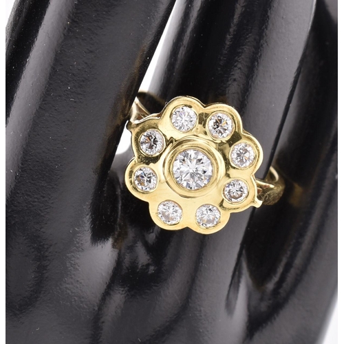 14 - A hallmarked 18ct gold and diamond 'hand made' cluster ring. The ring mounted with 9 bezel set round... 