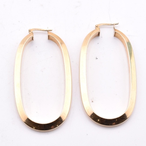 151 - A pair of Italian hallmarked 9ct gold hoop earrings. The 9ct yellow gold oval hoop earrings having a... 