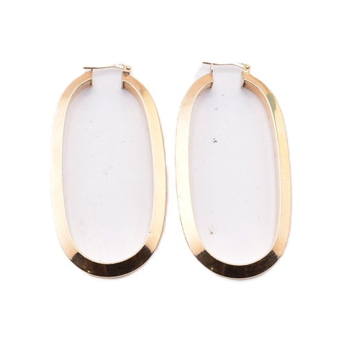 151 - A pair of Italian hallmarked 9ct gold hoop earrings. The 9ct yellow gold oval hoop earrings having a... 