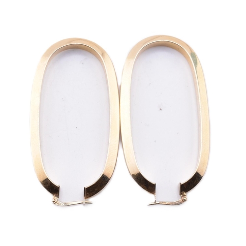 151 - A pair of Italian hallmarked 9ct gold hoop earrings. The 9ct yellow gold oval hoop earrings having a... 