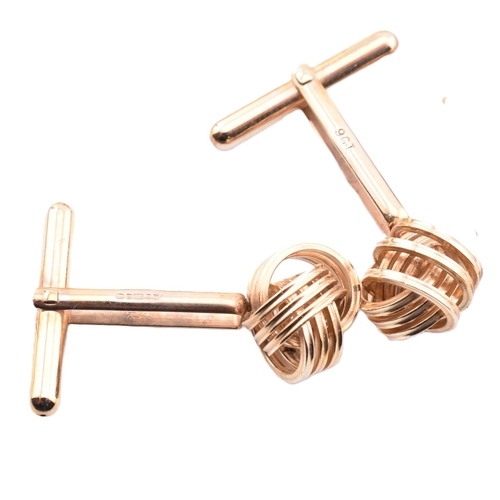 163 - Three pairs of cufflinks. The lot to include a pair of hallmarked 9ct yellow gold knot design cuffli... 