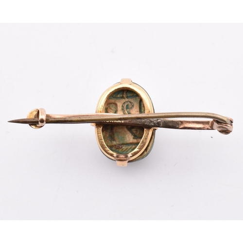 168 - A 14ct gold scarab beetle brooch pin. The 14ct bar brooch pin set with a central set scarab beetle t... 