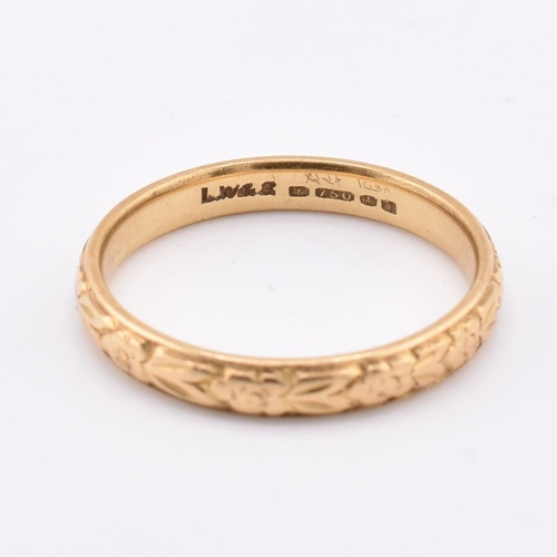 172 - A hallmarked 18ct gold band ring. The ring having foliate decoration to the band. Hallmarked for Lon... 