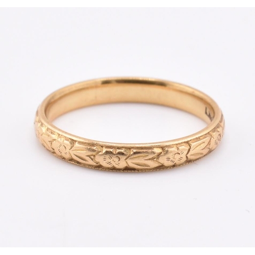 172 - A hallmarked 18ct gold band ring. The ring having foliate decoration to the band. Hallmarked for Lon... 