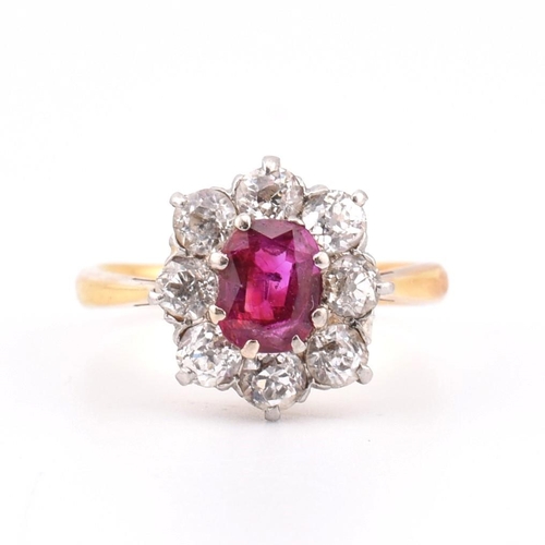 18 - An early 20th century 18ct gold and platinum diamond and ruby cluster ring. The 18ct yellow ring hav... 