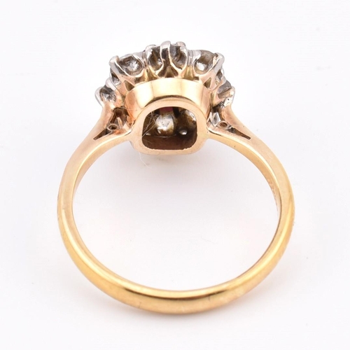 18 - An early 20th century 18ct gold and platinum diamond and ruby cluster ring. The 18ct yellow ring hav... 