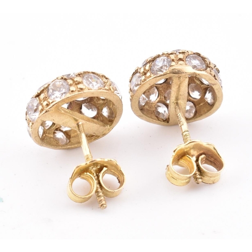 185 - A pair of hallmarked 9ct gold and CZ cluster stud earrings. The 9ct yellow gold stud earrings set a ... 