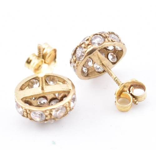 185 - A pair of hallmarked 9ct gold and CZ cluster stud earrings. The 9ct yellow gold stud earrings set a ... 