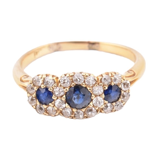 186 - An 18ct gold sapphire and diamond triple daisy cluster ring. The 18ct yellow gold cluster ring havin... 