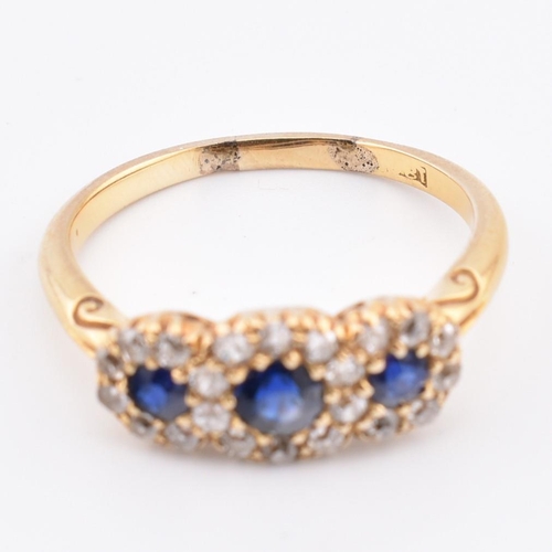 186 - An 18ct gold sapphire and diamond triple daisy cluster ring. The 18ct yellow gold cluster ring havin... 