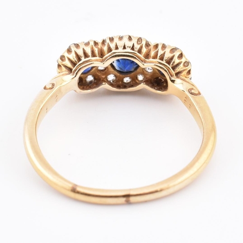 186 - An 18ct gold sapphire and diamond triple daisy cluster ring. The 18ct yellow gold cluster ring havin... 