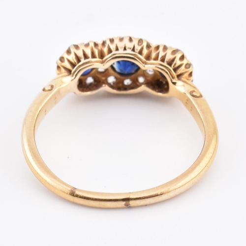 186 - An 18ct gold sapphire and diamond triple daisy cluster ring. The 18ct yellow gold cluster ring havin... 