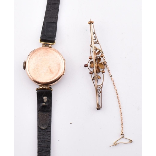 205 - A 15ct gold and gem set brooch pin together with a hallmarked gold wristwatch. The lot to include a ... 