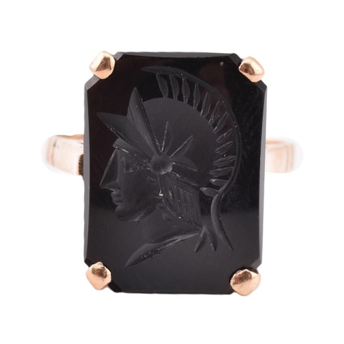 209 - A 9ct gold and onyx Roman soldier intaglio ring. The 9ct yellow gold ring set with onyx carved with ... 