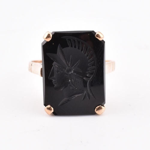 209 - A 9ct gold and onyx Roman soldier intaglio ring. The 9ct yellow gold ring set with onyx carved with ... 