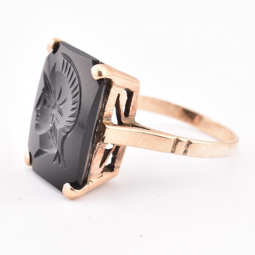 209 - A 9ct gold and onyx Roman soldier intaglio ring. The 9ct yellow gold ring set with onyx carved with ... 