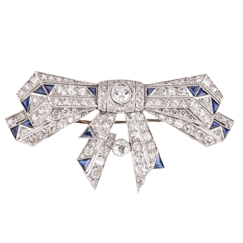 21 - An Art Deco ribbon bow sapphire and diamond brooch pin. The brooch set 104 old and eight cut diamond... 