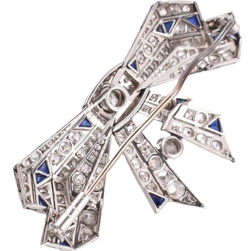 21 - An Art Deco ribbon bow sapphire and diamond brooch pin. The brooch set 104 old and eight cut diamond... 