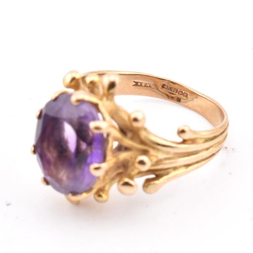 243 - A hallmarked 9ct gold and amethyst cocktail ring. The 9ct yellow gold ring having a single eight cla... 