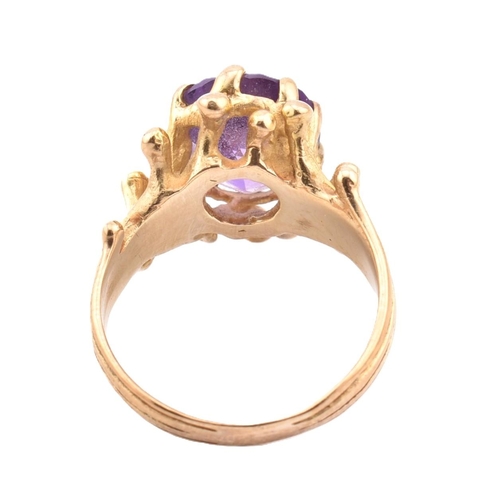 243 - A hallmarked 9ct gold and amethyst cocktail ring. The 9ct yellow gold ring having a single eight cla... 