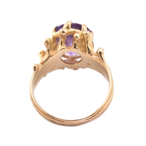 243 - A hallmarked 9ct gold and amethyst cocktail ring. The 9ct yellow gold ring having a single eight cla... 