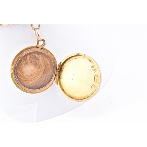 25 - An early 20th-century 18ct gold bracelet and engraved locket. The 18ct yellow gold curb link chain h... 