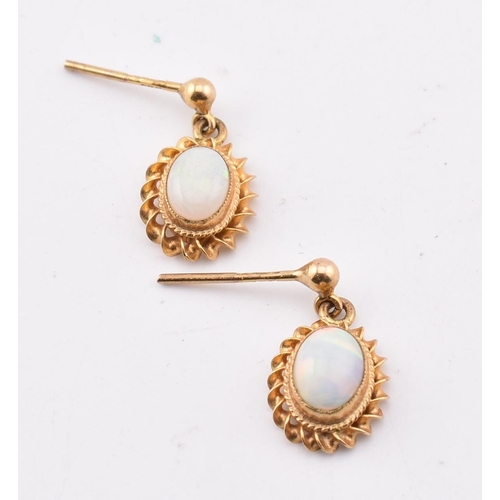 265 - A pair of hallmarked 9ct gold and opal pendant earrings AF. The 9ct yellow gold earrings having a mi... 