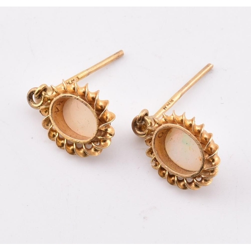 265 - A pair of hallmarked 9ct gold and opal pendant earrings AF. The 9ct yellow gold earrings having a mi... 