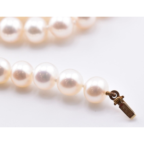 269 - A cultured pearl necklace and earrings. The single strand necklace strung with cultured pearls to a ... 