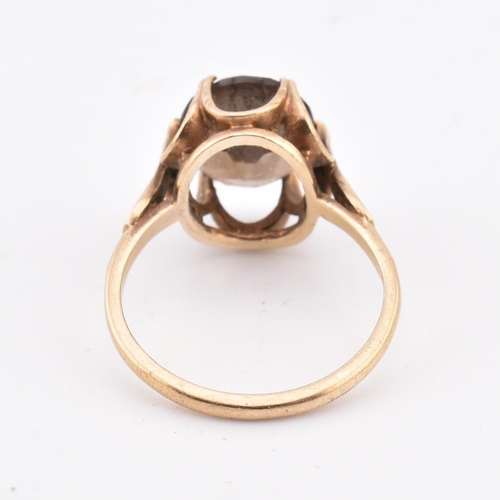 278 - A hallmarked 9ct gold and smoky quartz ring. The 9ct yellow gold ring set with a three-claw set oval... 