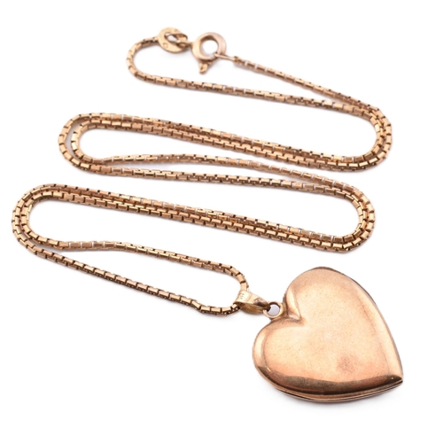 279 - A 10ct gold heart locket pendant on an 18ct gold chain necklace. The 10ct gold heart locket pendant ... 