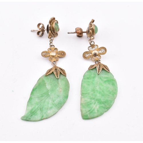 280 - A pair of silver and jade pendant earrings. The earrings having a jade pendant in the form of a leaf... 