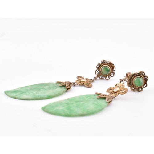 280 - A pair of silver and jade pendant earrings. The earrings having a jade pendant in the form of a leaf... 